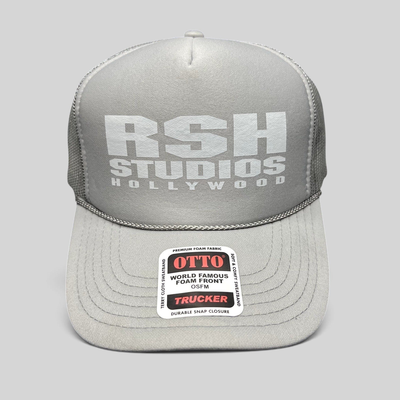 Raree Finds RSH Studios Hollywood gray trucker hat with white tonal print, mesh back, and braided brim rope detail.