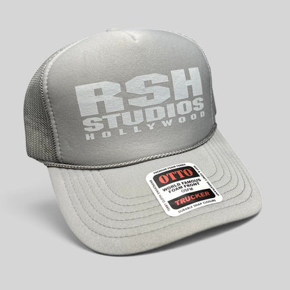 Raree Finds gray RSH Studios Hollywood trucker hat with white print, mesh back, and braided rope detail on the brim.
