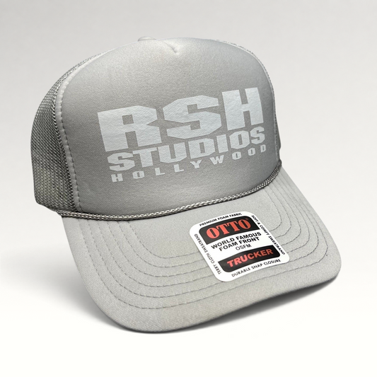 Raree Finds gray RSH Studios Hollywood trucker hat with white print, mesh back, and braided rope detail on the brim.