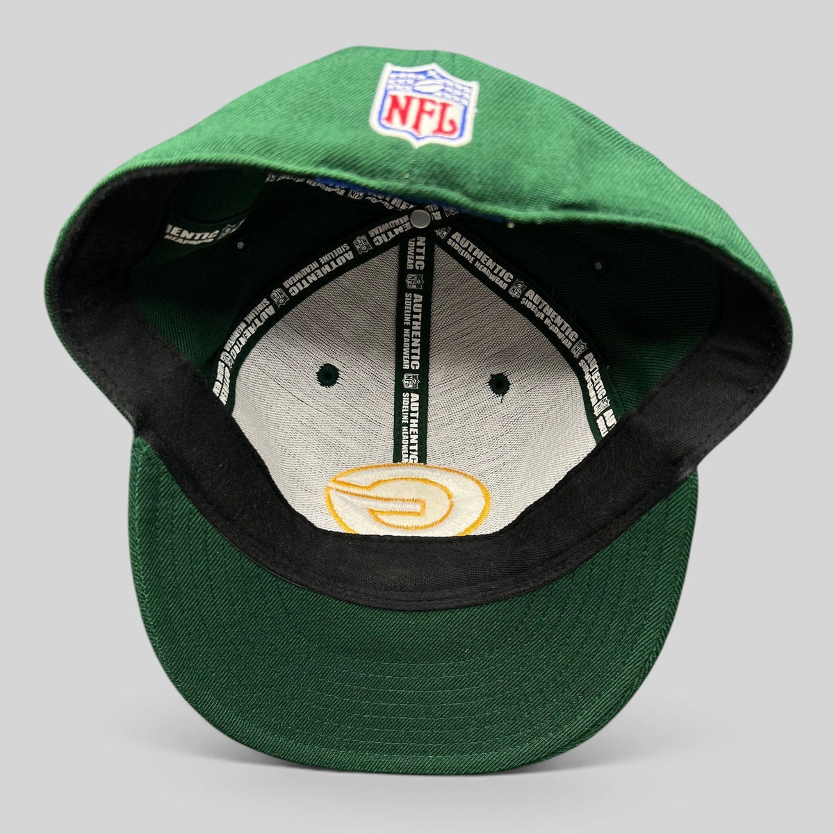 Raree Finds vintage Reebok Green Bay Packers on-field fitted hat showing interior branding and NFL logo embroidery.