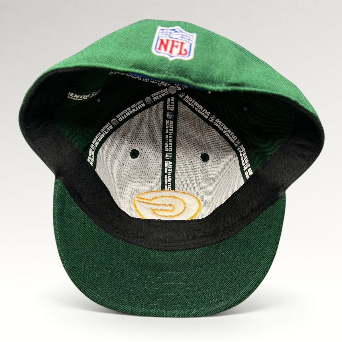 Raree Finds vintage Reebok Green Bay Packers on-field fitted hat showing interior branding and NFL logo embroidery.