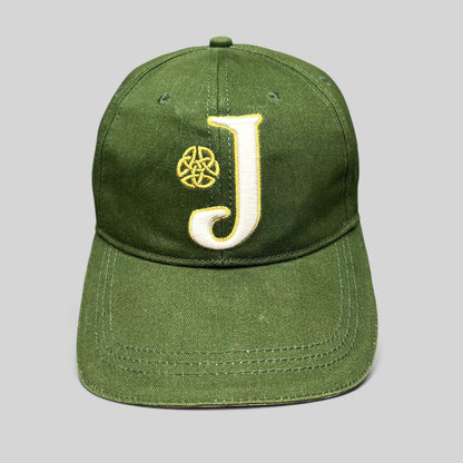 Raree Finds dark green strapback hat with an embroidered white J logo and gold Celtic knot symbol on the front.