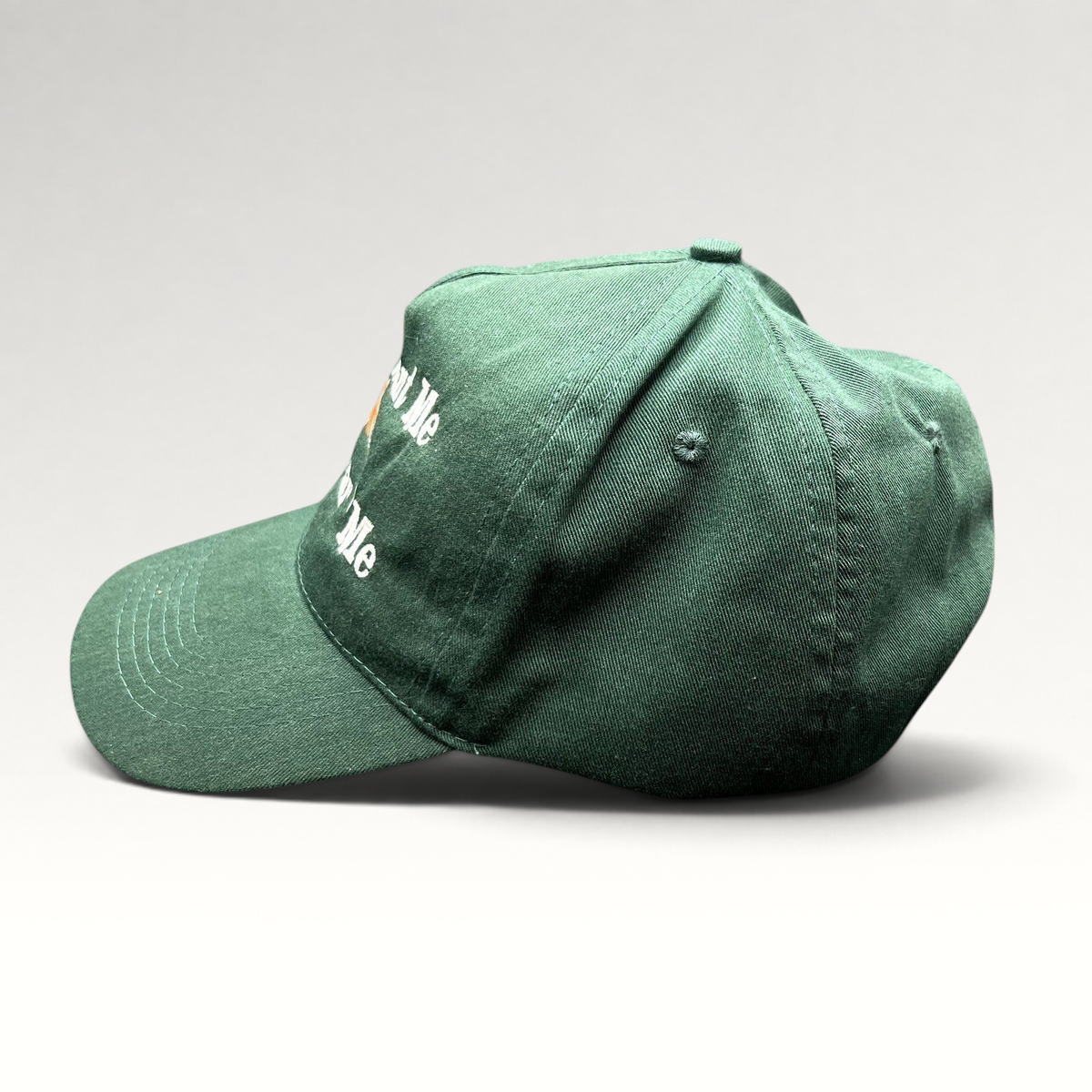 Raree Finds forest green dad cap with Women Want Me Fish Fear Me embroidery and fishing lure graphic, side view