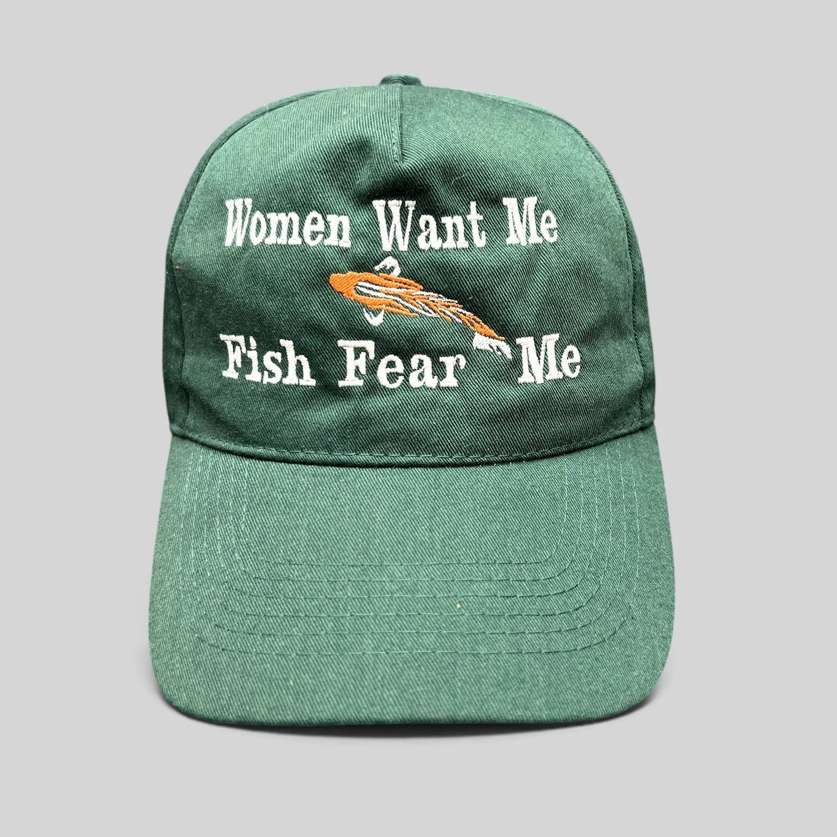 Raree Finds forest green dad cap with Women Want Me Fish Fear Me embroidery and an orange fishing lure graphic.