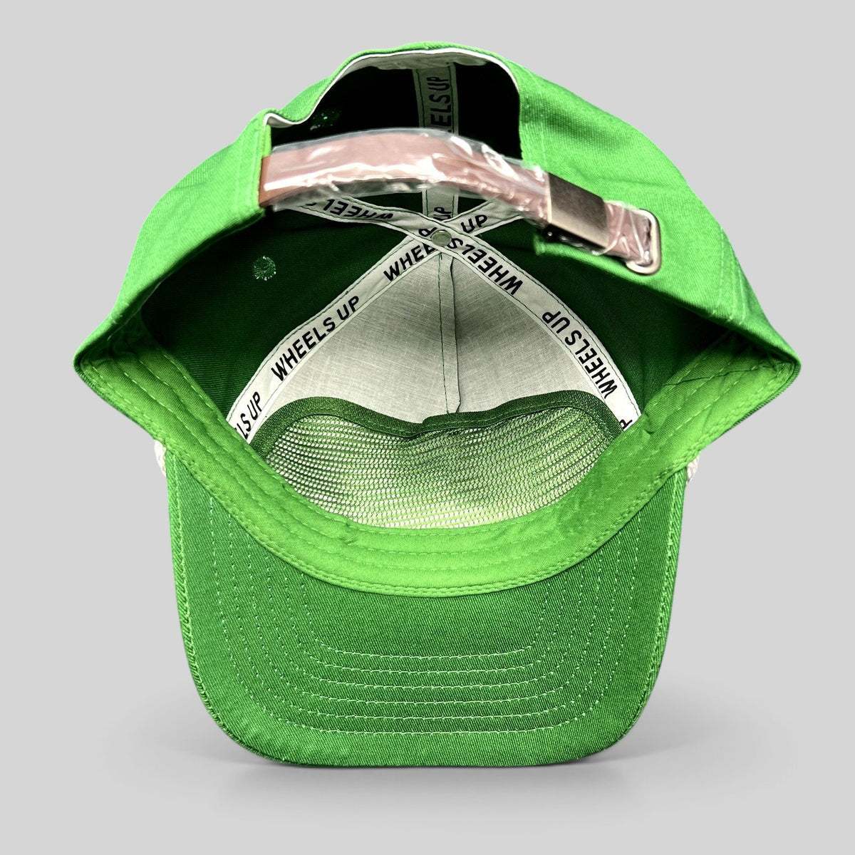 Raree Finds green strapback cap with internal Wheels Up branded taping and adjustable metal strap closure