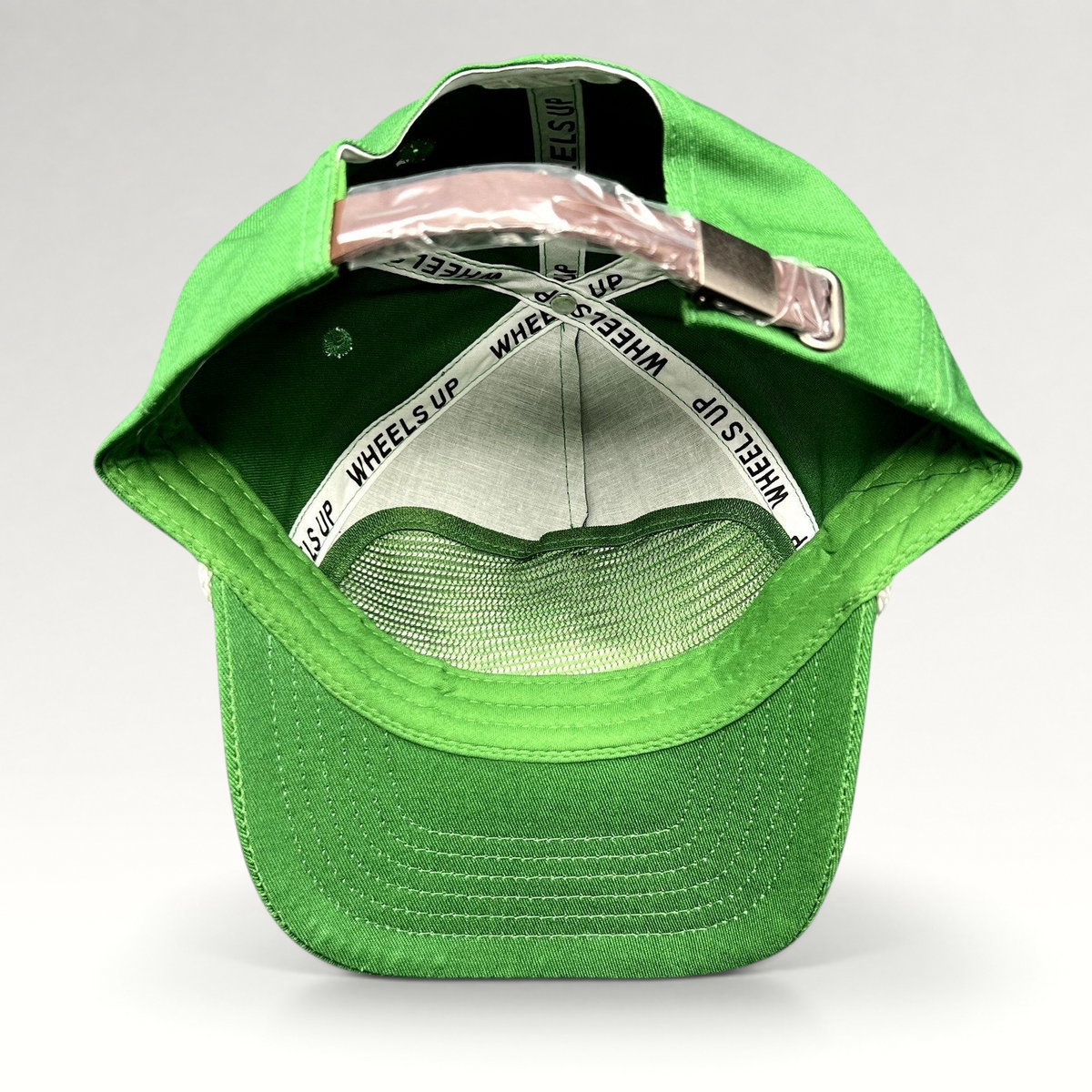 Raree Finds green strapback cap with internal Wheels Up branded taping and adjustable metal strap closure