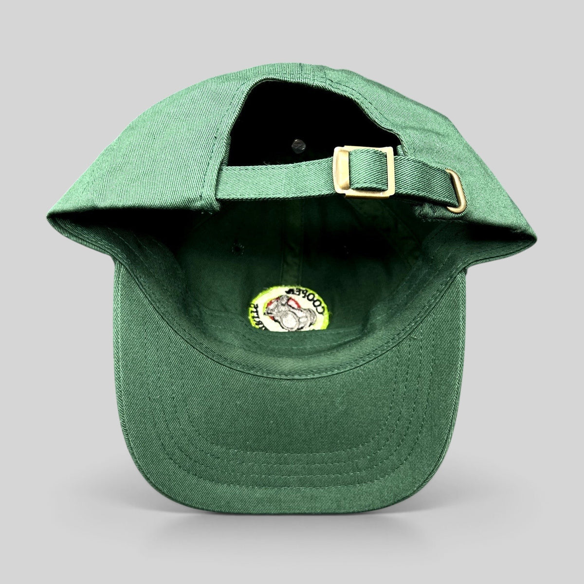 Raree Finds forest green cotton strapback hat with adjustable brass buckle closure and interior logo detail