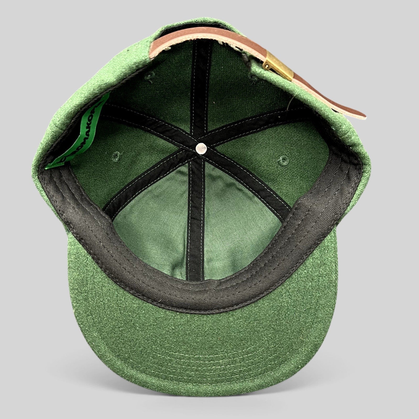 Raree Finds forest green wool-style strapback hat interior view with leather strap and brass hardware