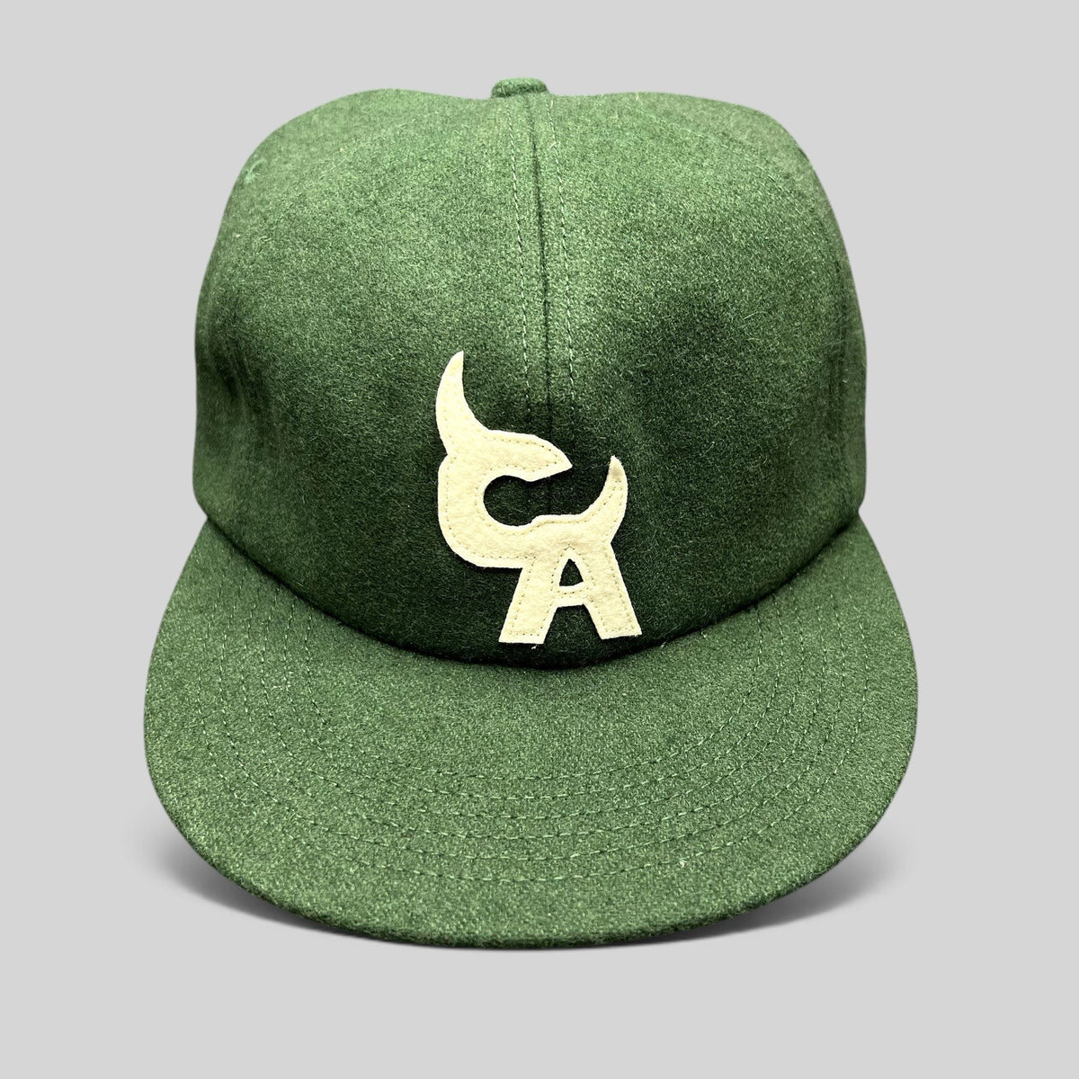 Raree Finds forest green wool-style strapback hat with cream embroidered Chromakopia logo and flat bill design.