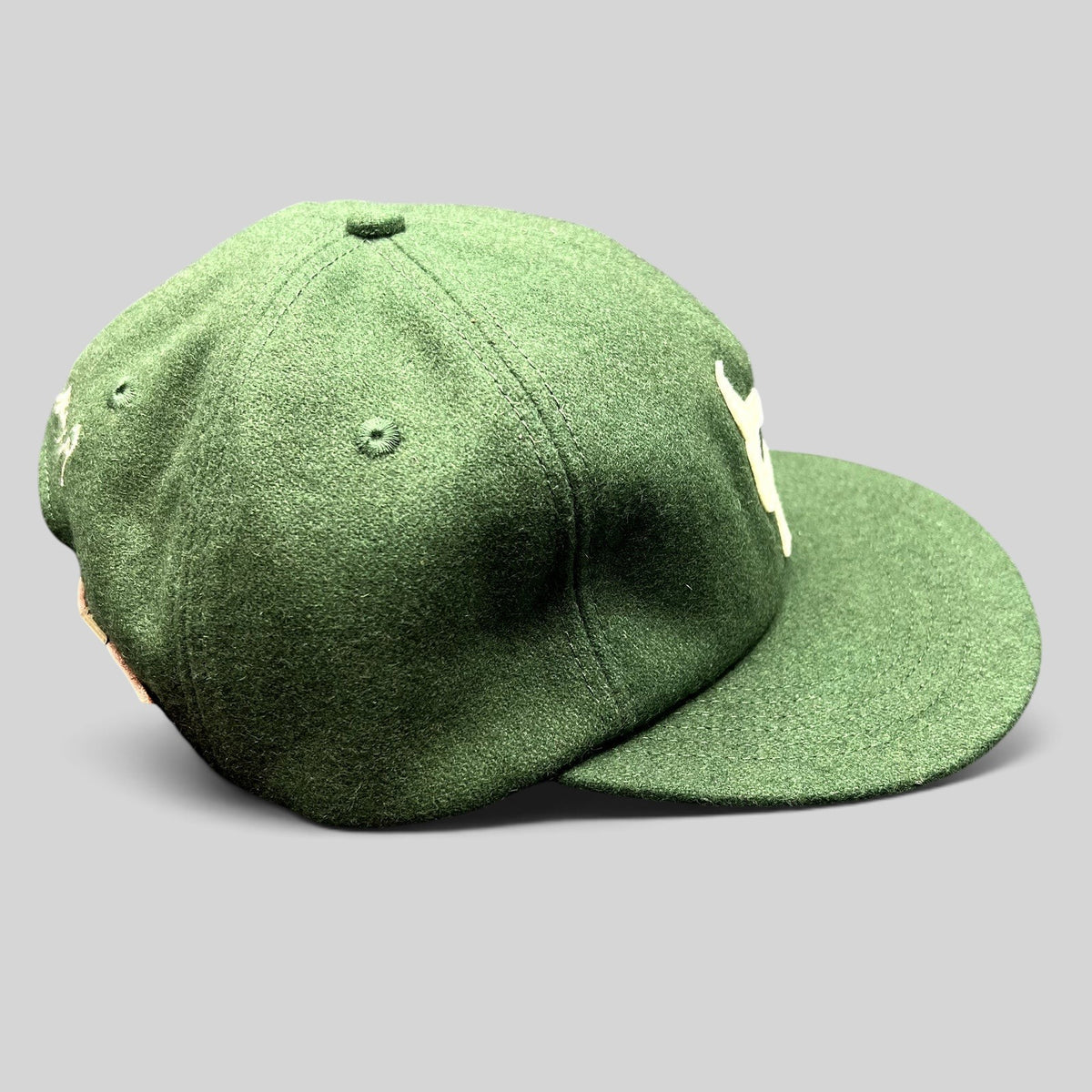 Raree Finds forest green wool strapback hat with cream embroidered logo and flat bill, streetwear style.