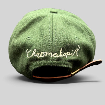 Raree Finds forest green wool strapback hat featuring cream Chromakopia embroidery and an adjustable leather strap