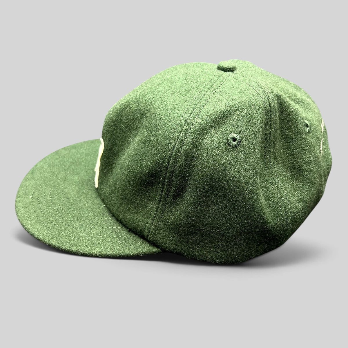 Raree Finds forest green wool-style strapback hat with cream embroidered logo and flat bill streetwear design