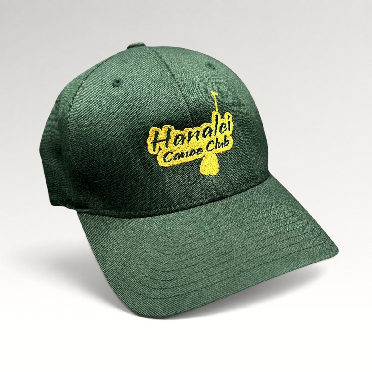 Raree Finds forest green Hanalei Canoe Club Flexfit hat with gold embroidered paddle logo on the front