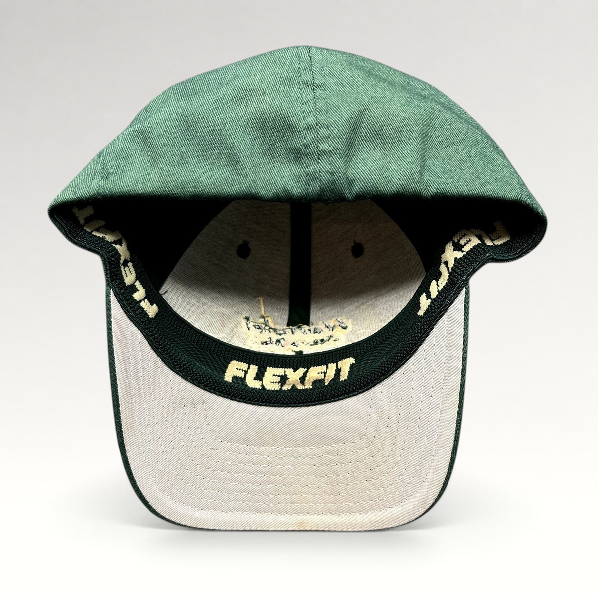 Raree Finds forest green Hanalei Canoe Club Flexfit hat with gold interior branding and stretch-fit construction