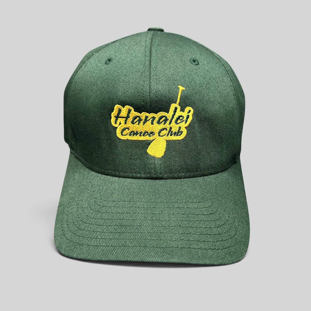 Raree Finds forest green Hanalei Canoe Club Flexfit hat with gold embroidered paddle logo on the front