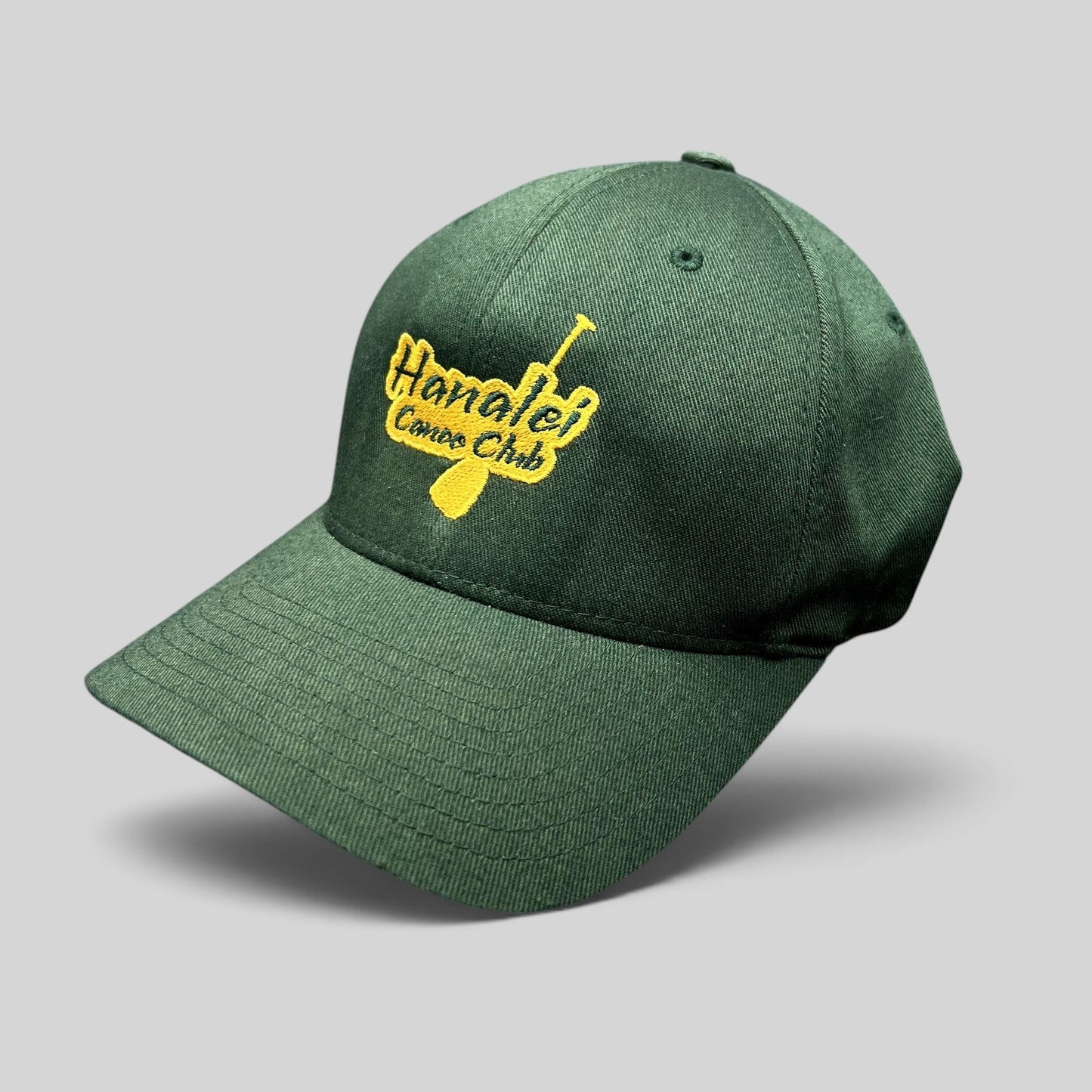 Raree Finds forest green Hanalei Canoe Club Flexfit hat with gold embroidered paddle logo on the front