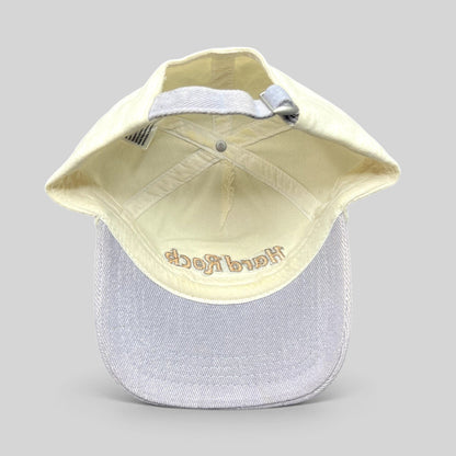 Raree Finds Hard Rock Cafe strapback hat with cream crown, lavender brim, and adjustable metal slider buckle.