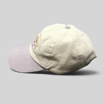 Raree Finds Hard Rock Cafe pastel dad hat with a cream cotton crown and lavender brim, side profile view.