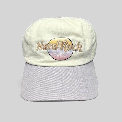 Raree Finds Hard Rock Cafe strapback hat with a cream cotton crown, lavender brim, and pastel embroidered logo.