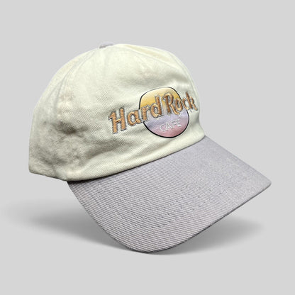 Raree Finds Hard Rock Cafe strapback hat with a cream cotton crown, lavender brim, and pastel embroidered logo.