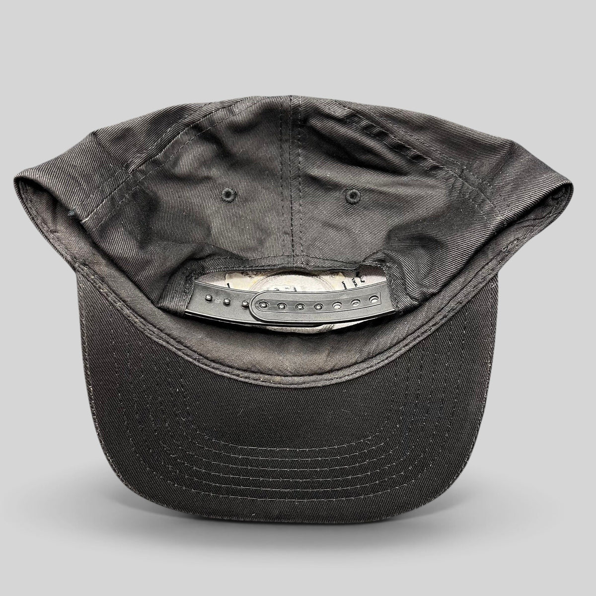 Raree Finds vintage Hard Rock Cafe black cotton snapback hat showing the adjustable plastic strap closure from behind
