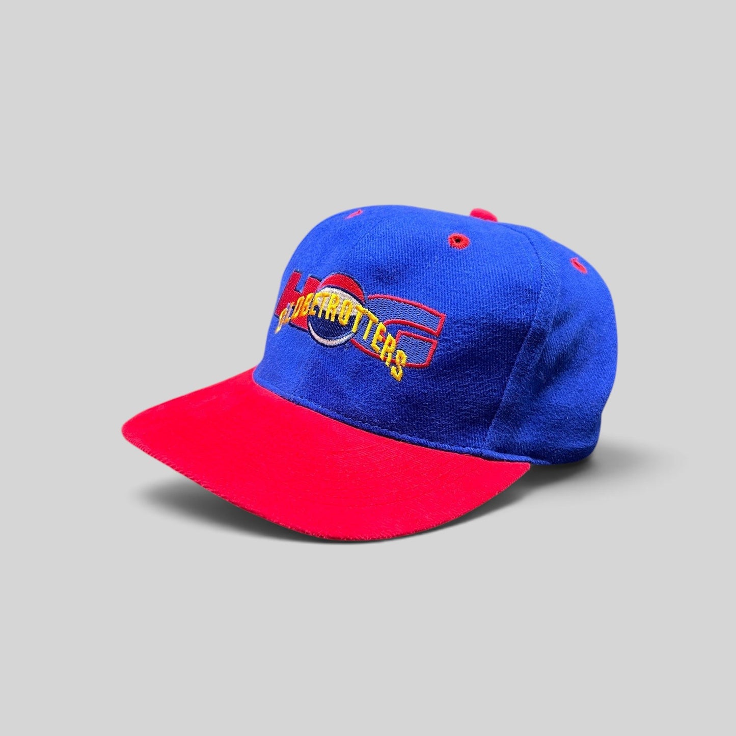 Raree Finds vintage 90s Harlem Globetrotters snapback hat with a royal blue crown, red brim, and embroidered logo.