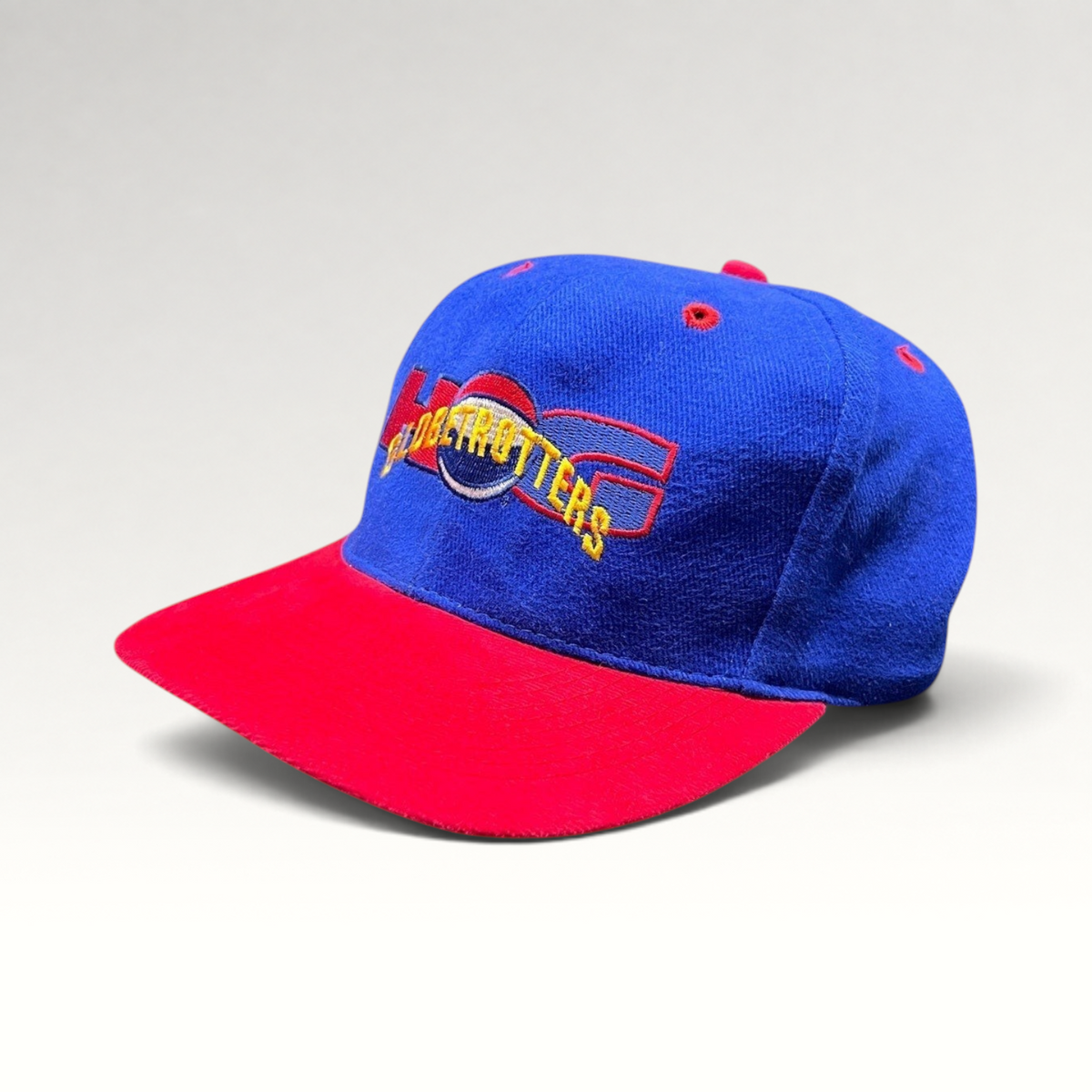 Raree Finds vintage 90s Harlem Globetrotters snapback hat with a royal blue crown, red brim, and embroidered logo.