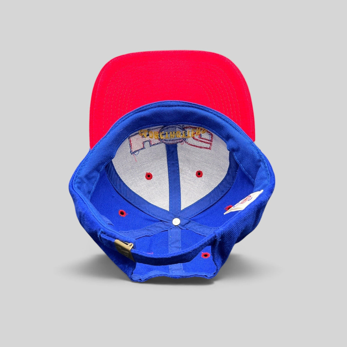 Raree Finds vintage 90s Harlem Globetrotters snapback hat interior showing red brim and blue crown construction