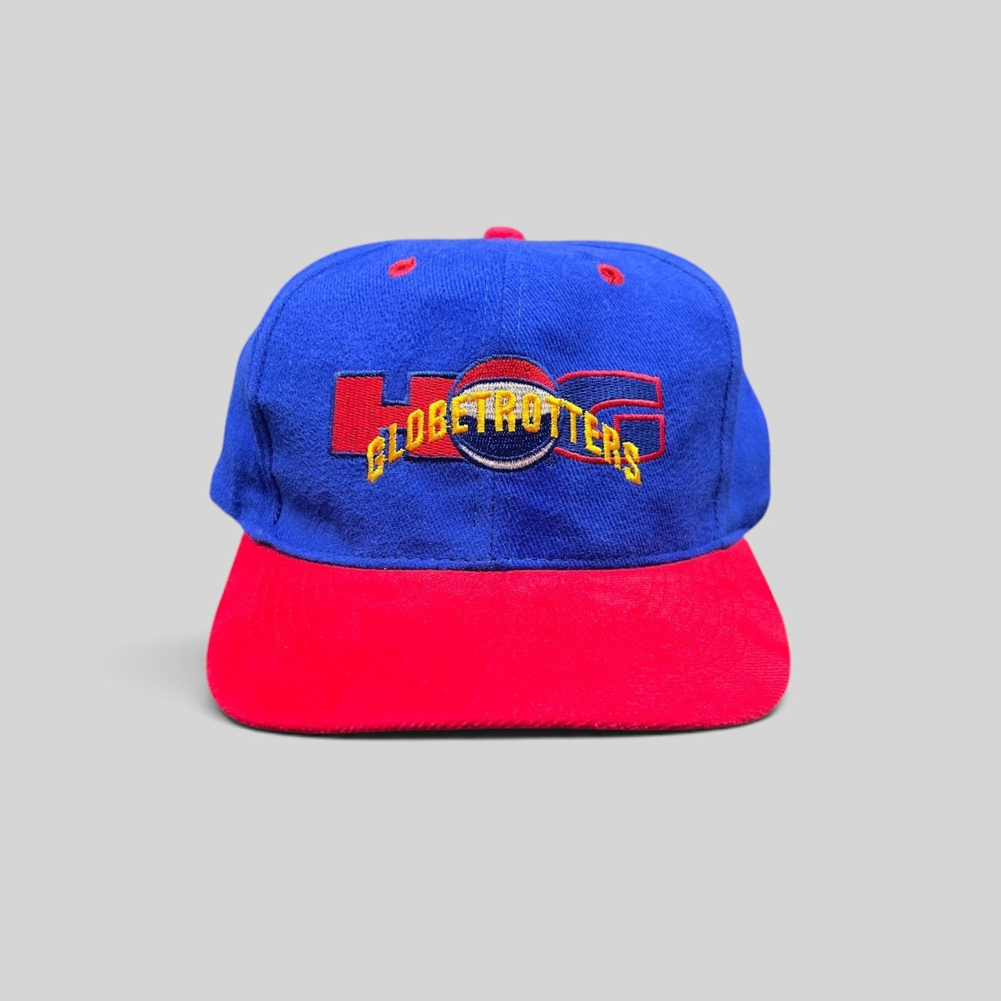 Raree Finds vintage 90s Harlem Globetrotters snapback hat with a royal blue crown, red brim, and embroidered logo.
