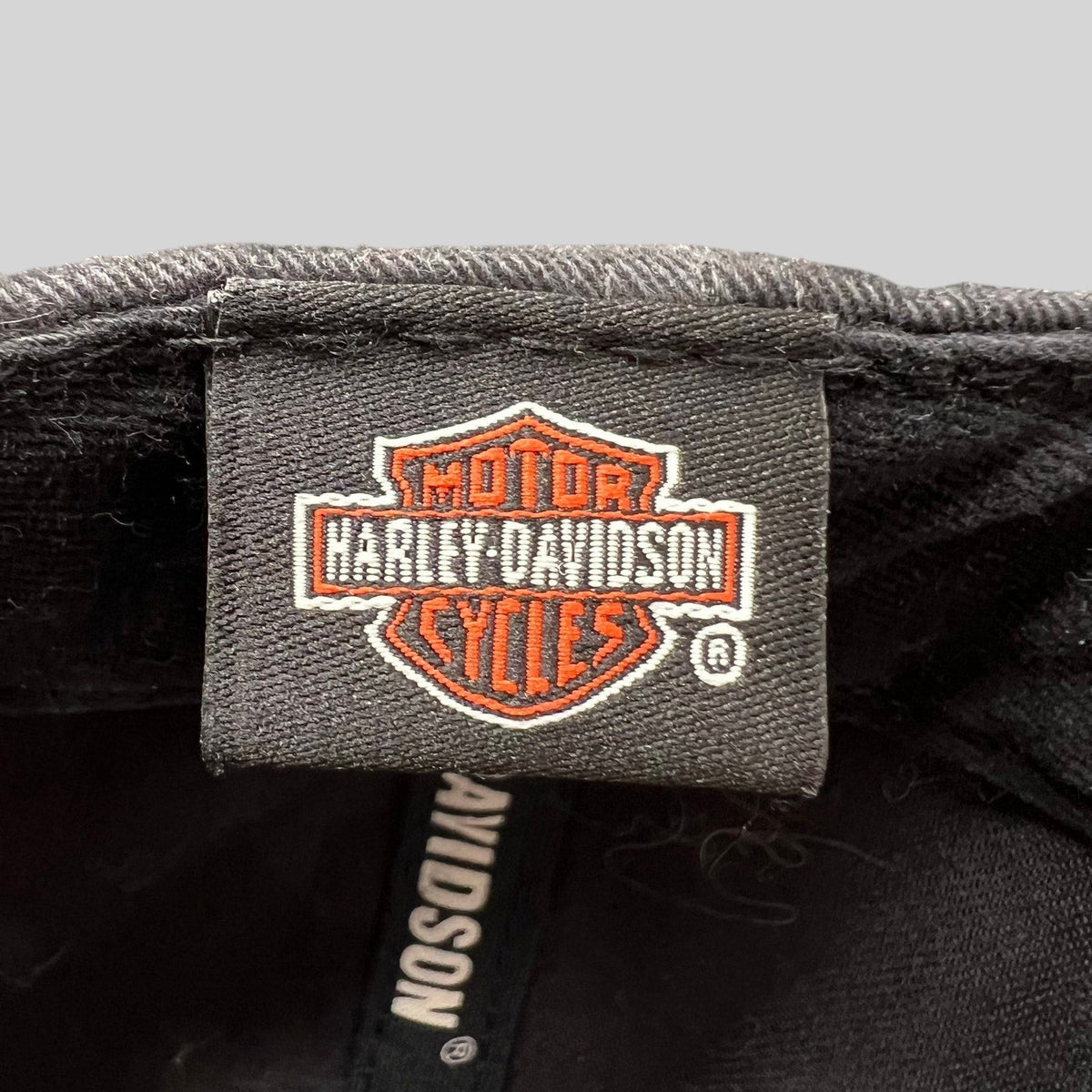 Raree Finds Harley-Davidson black cotton hat interior tag with classic orange and white bar and shield logo