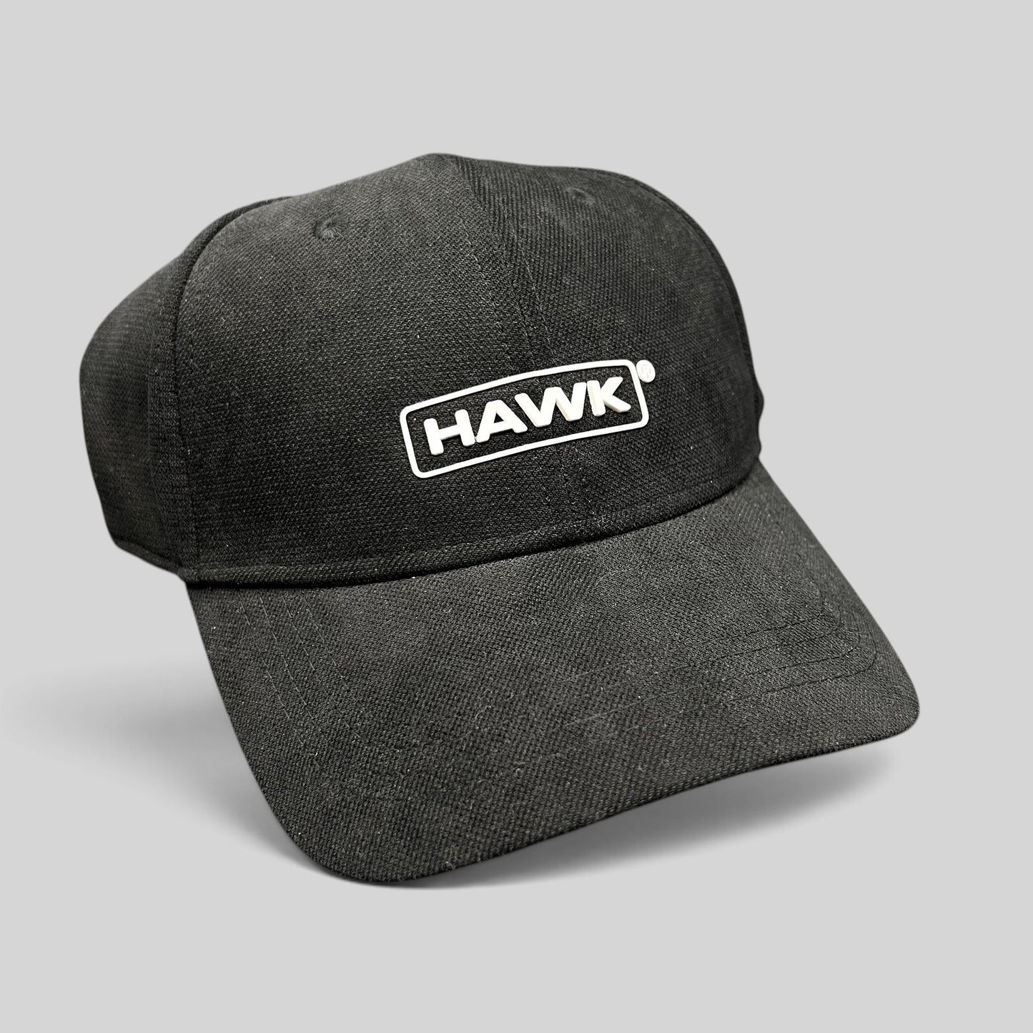 Raree Finds black HAWK strapback hat in lightweight polyamide with a white embroidered boxed logo on the front.