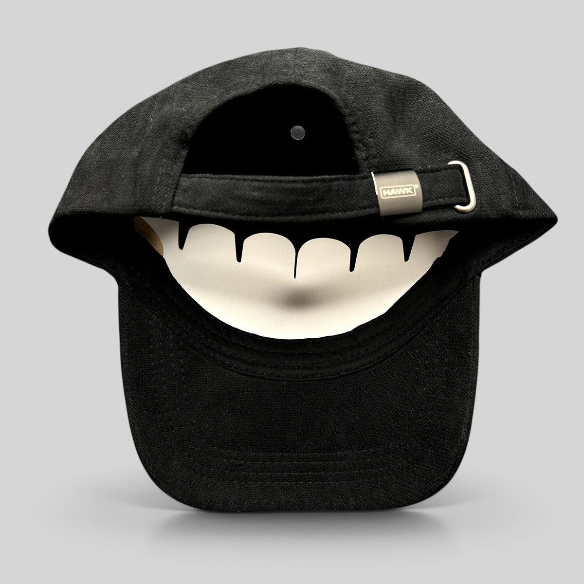 Raree Finds HAWK black polyamide strapback hat showing the adjustable fabric strap and branded metal buckle detail.