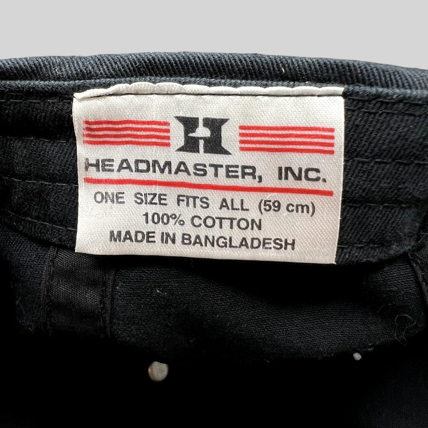 Raree Finds black cotton strapback hat interior tag showing Headmaster Inc branding and 100 percent cotton material