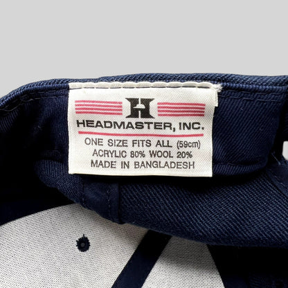 Raree Finds Headmaster hat interior tag showing brand logo, material composition, and origin on navy blue fabric