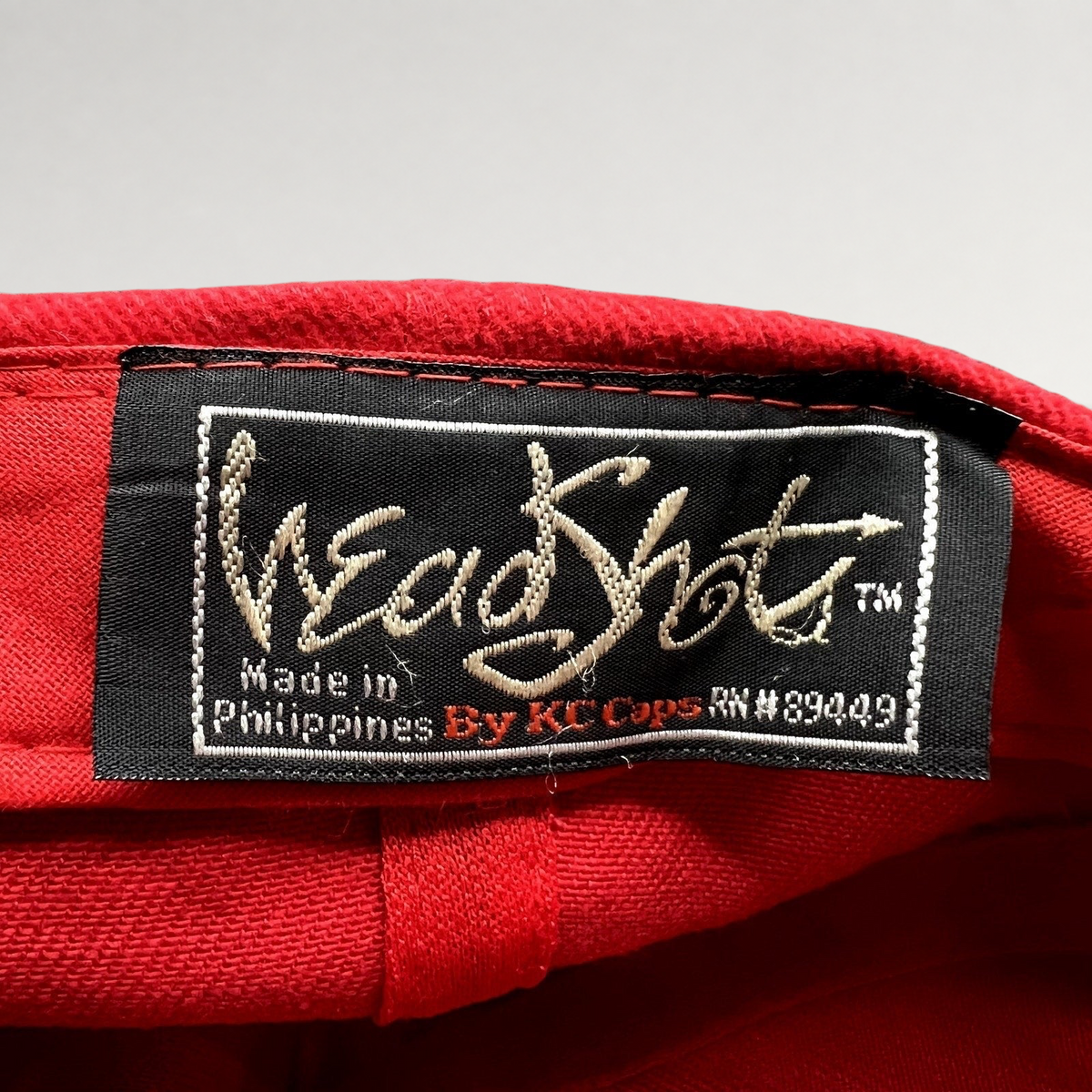 Raree Finds vintage Headshots by KC Caps label inside a bright red promotional hat made in the Philippines