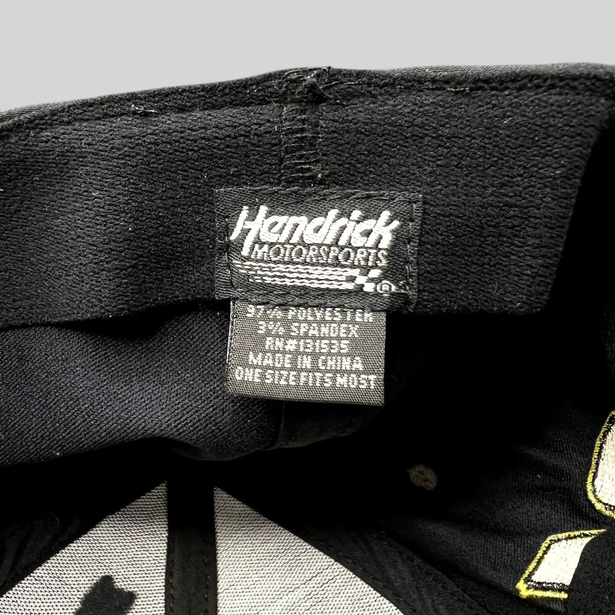 Raree Finds Hendrick Motorsports hat interior tag showing polyester and spandex material composition