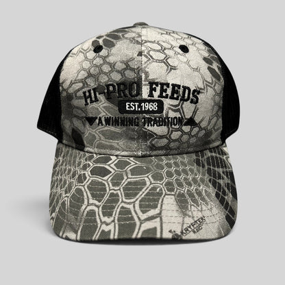 Raree Finds Hi-Pro Feeds trucker hat in gray and black Kryptek Raid camo with embroidered logo and mesh back.
