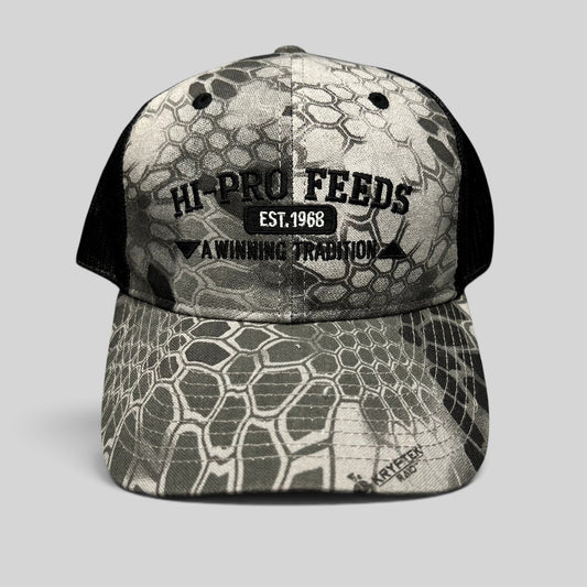 Raree Finds Hi-Pro Feeds trucker hat in gray and black Kryptek Raid camo with embroidered logo and mesh back.