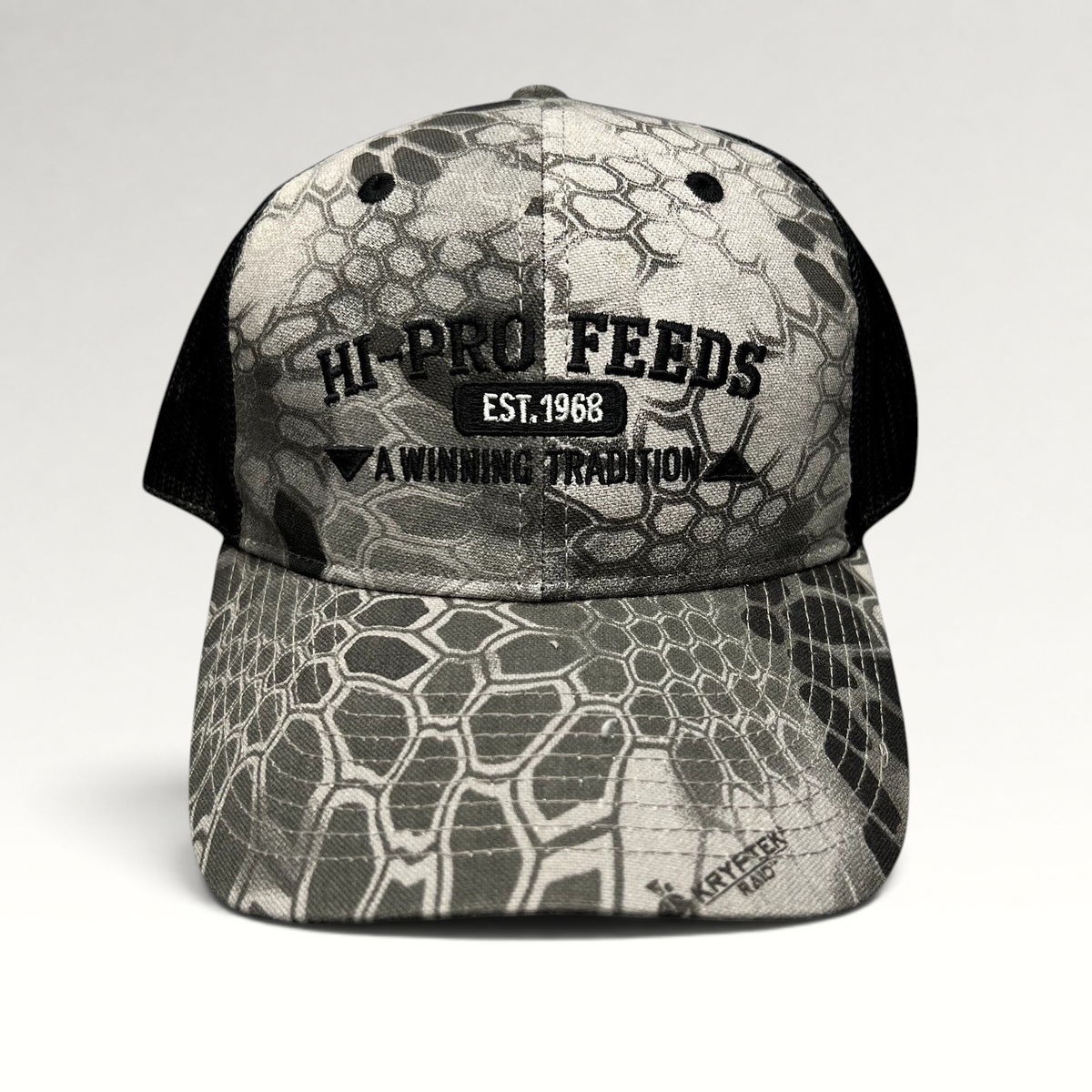 Raree Finds Hi-Pro Feeds trucker hat in gray and black Kryptek Raid camo with embroidered logo and mesh back.