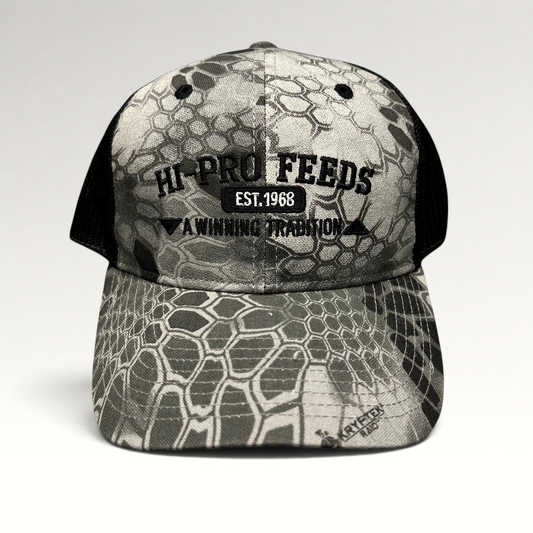 Raree Finds Hi-Pro Feeds trucker hat in gray and black Kryptek Raid camo with embroidered logo and mesh back.
