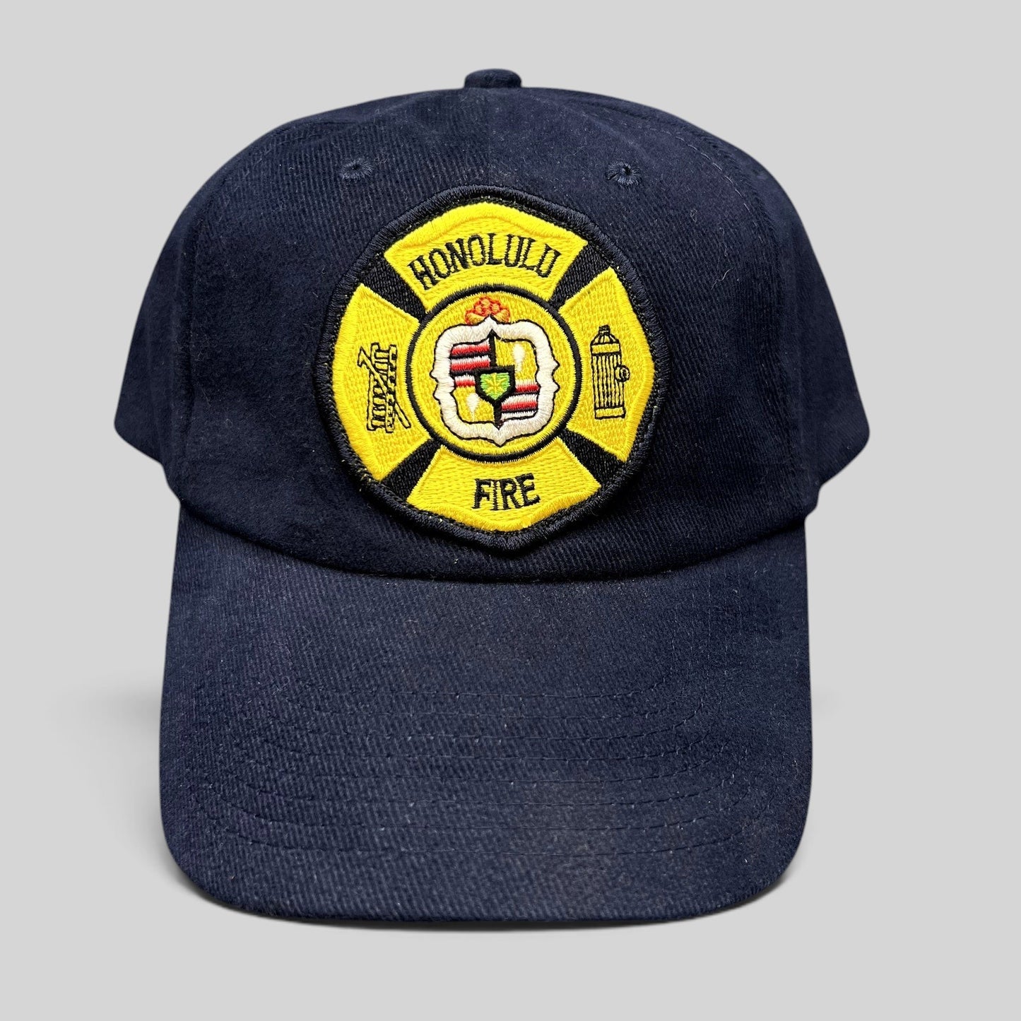 Raree Finds vintage navy blue Nissun strapback hat with a yellow Honolulu Fire Department embroidered patch