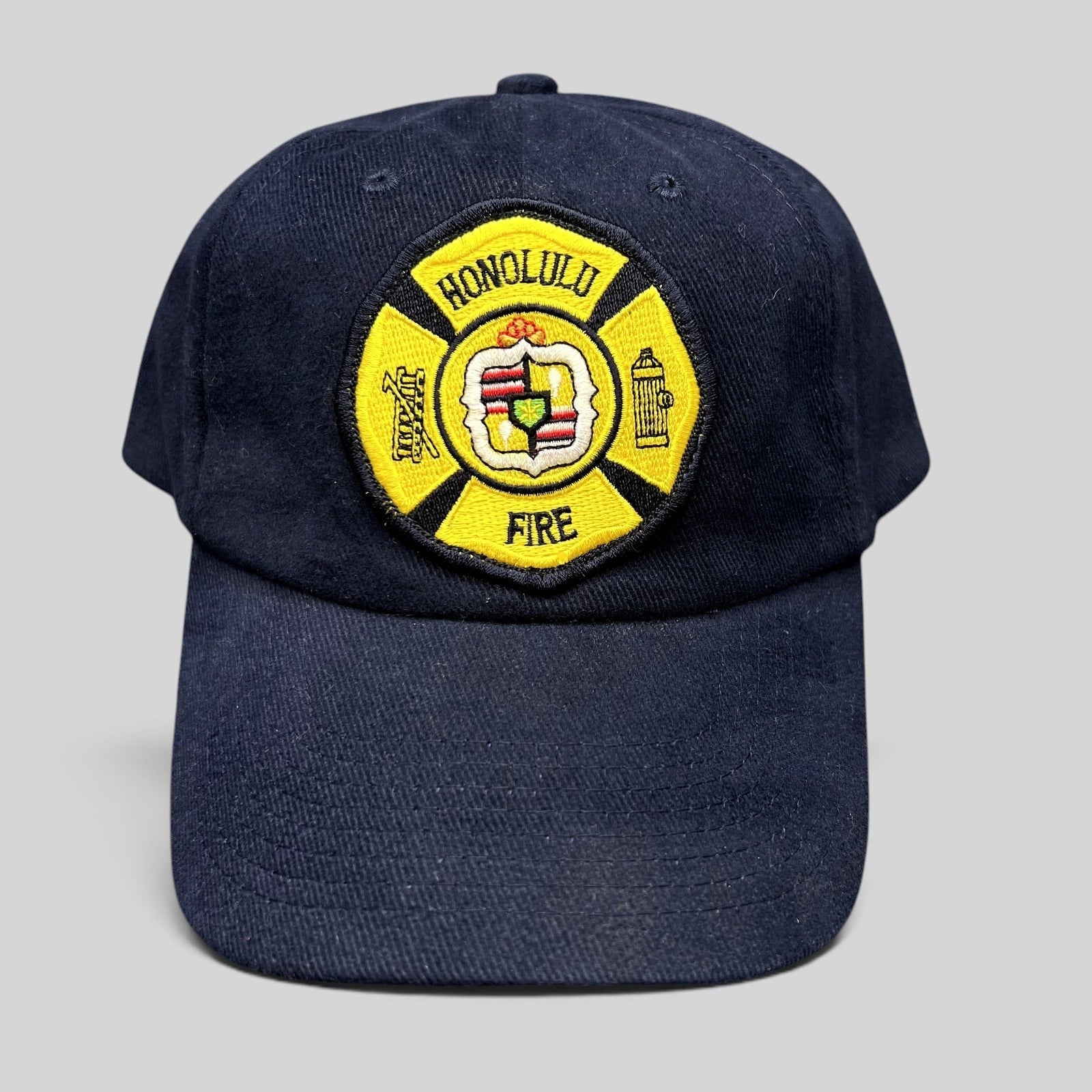 Raree Finds vintage navy blue Nissun strapback hat with a yellow Honolulu Fire Department embroidered patch