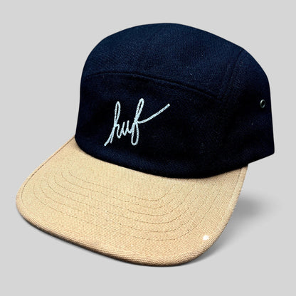 Raree Finds HUF black wool-style camp hat with a tan brim and white embroidered script logo on the front