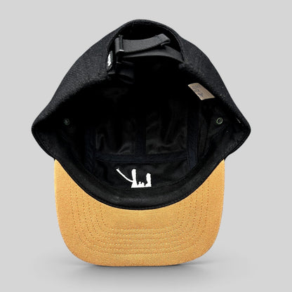 Raree Finds HUF black camp hat with tan brim and interior white script logo, featuring an adjustable strapback.