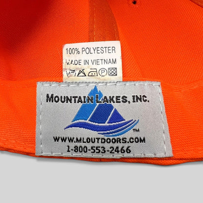 Raree Finds blaze orange hunting cap interior label showing Mountain Lakes Inc. branding and 100% polyester material