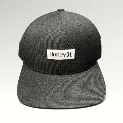 Raree Finds black Hurley snapback hat with a white woven logo patch on a structured Yupoong crown and flat brim.