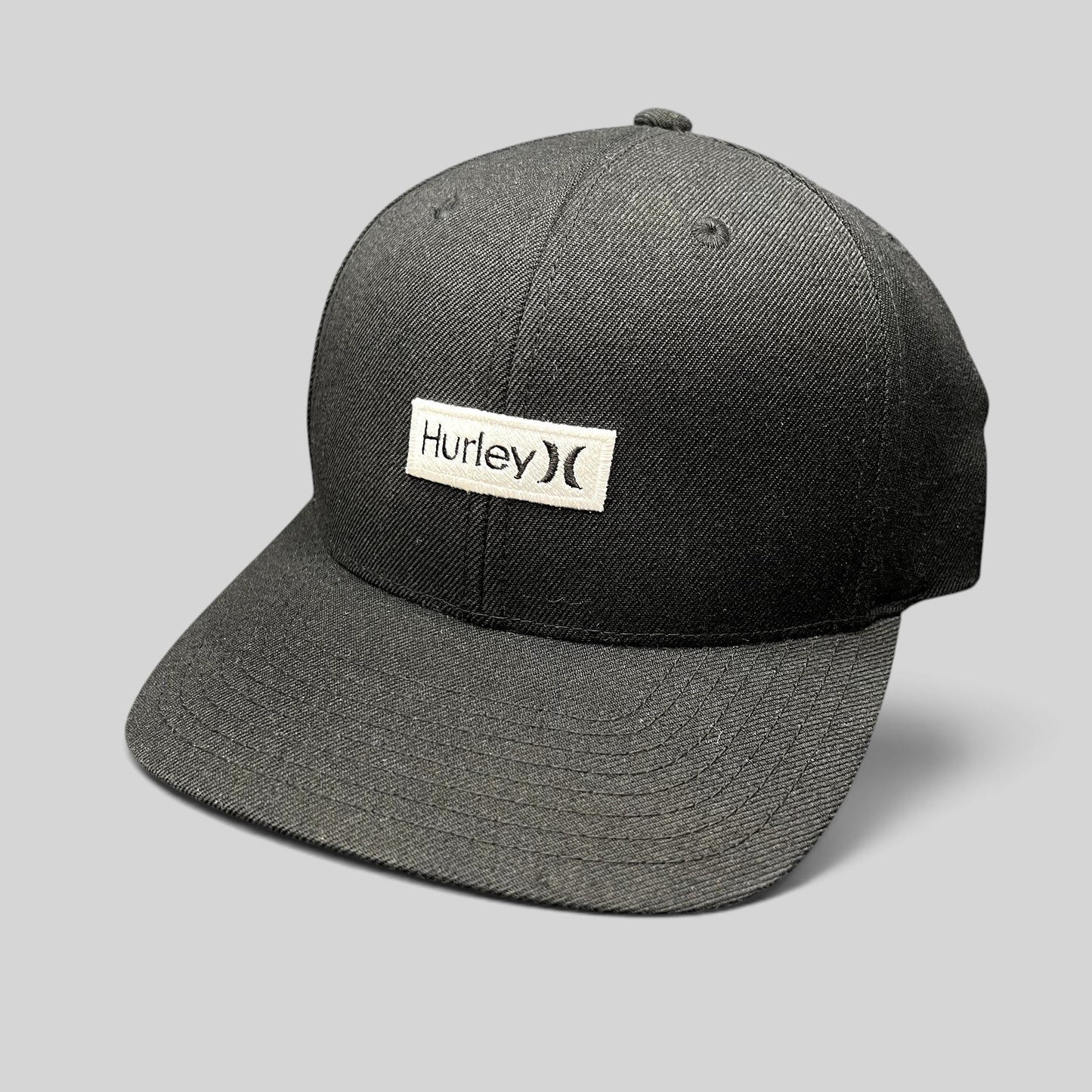Raree Finds black Hurley snapback hat with a white woven logo patch on a structured Yupoong crown and flat brim