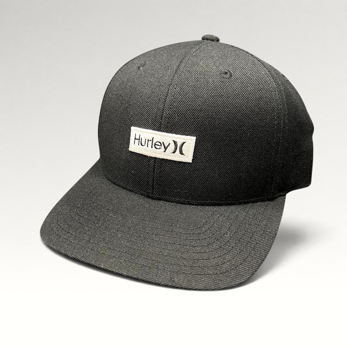 Raree Finds black Hurley snapback hat with a white woven logo patch on a structured Yupoong crown and flat brim