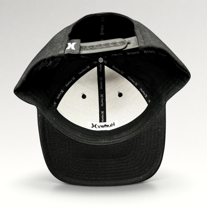 Raree Finds black Hurley Yupoong snapback hat interior view showing branded taping and adjustable plastic closure