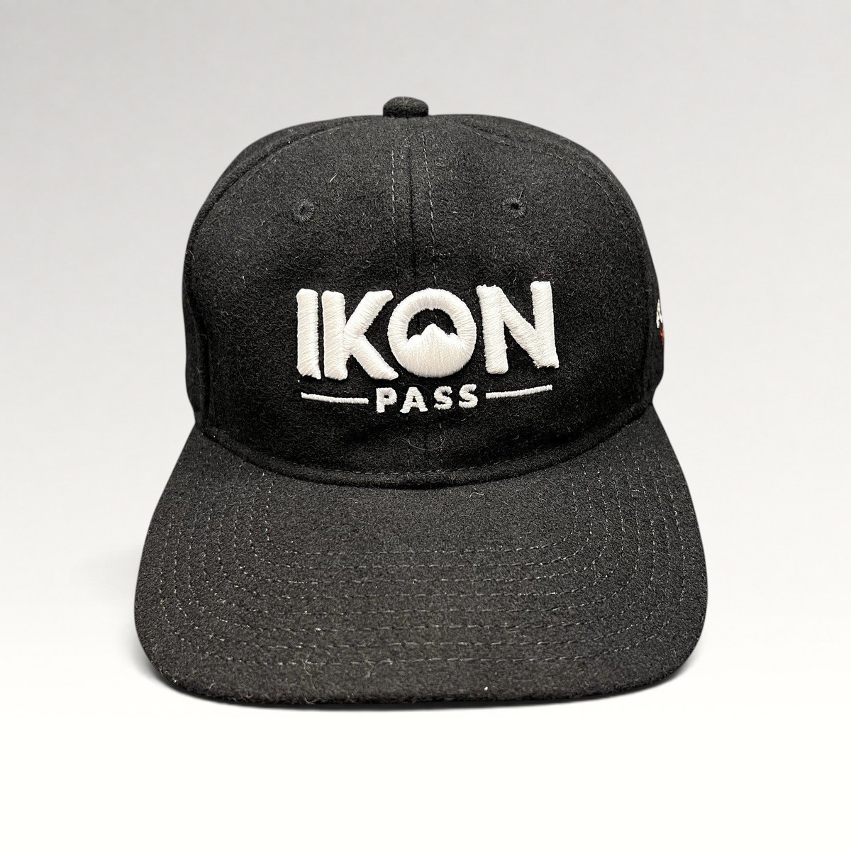 Raree Finds black wool-blend strapback hat with white embroidered Ikon Pass logo, perfect for winter sports.